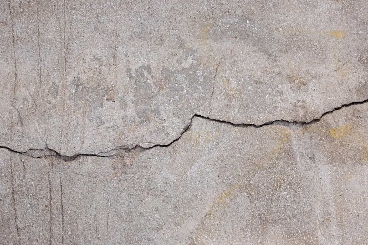 A crack running the full width of an aging concrete slab