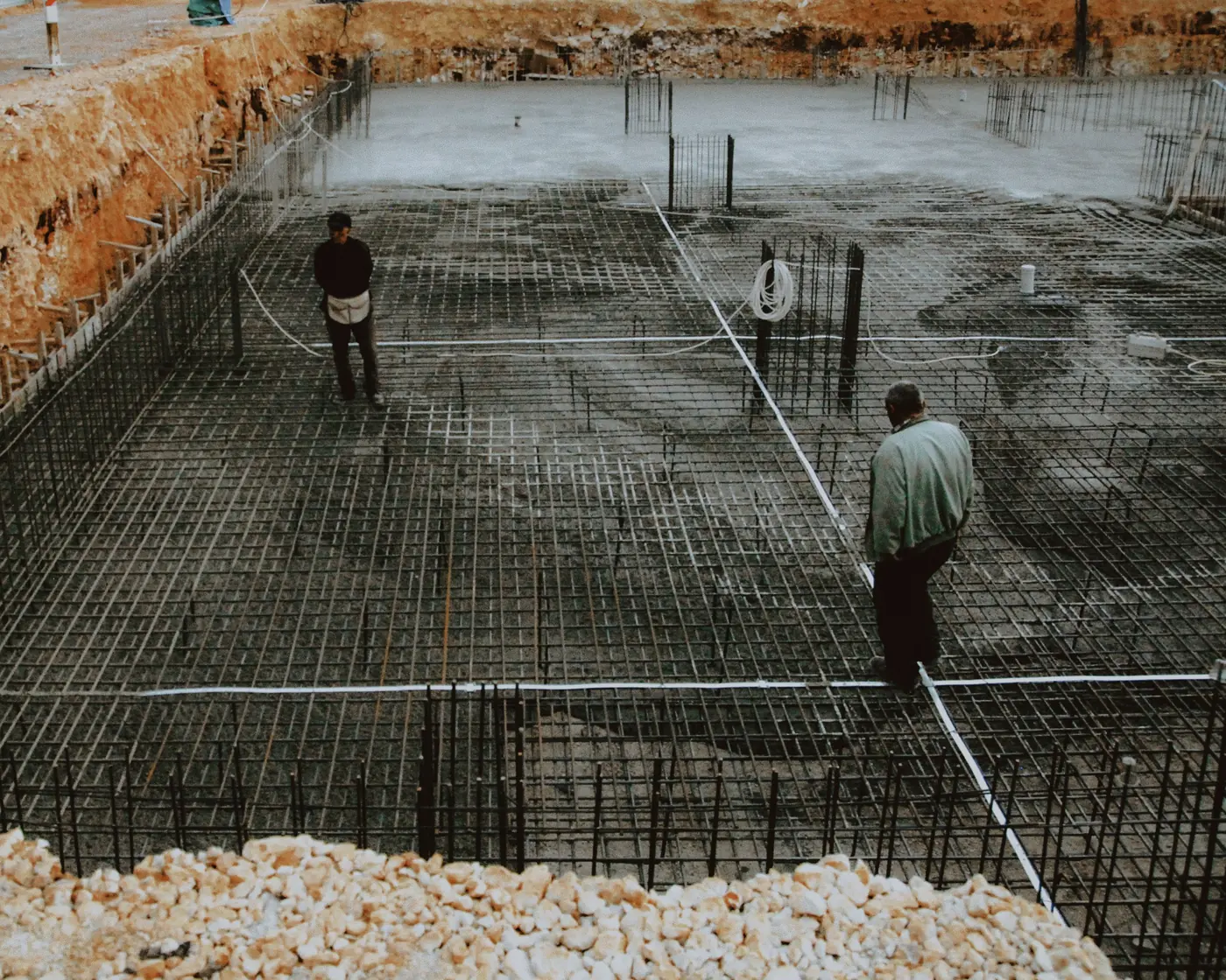A tied rebar grid laid over a compacted sub-base before the concrete pour