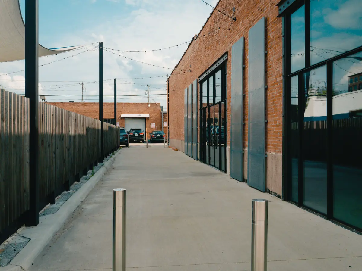 A poured concrete service apron running alongside a commercial building
