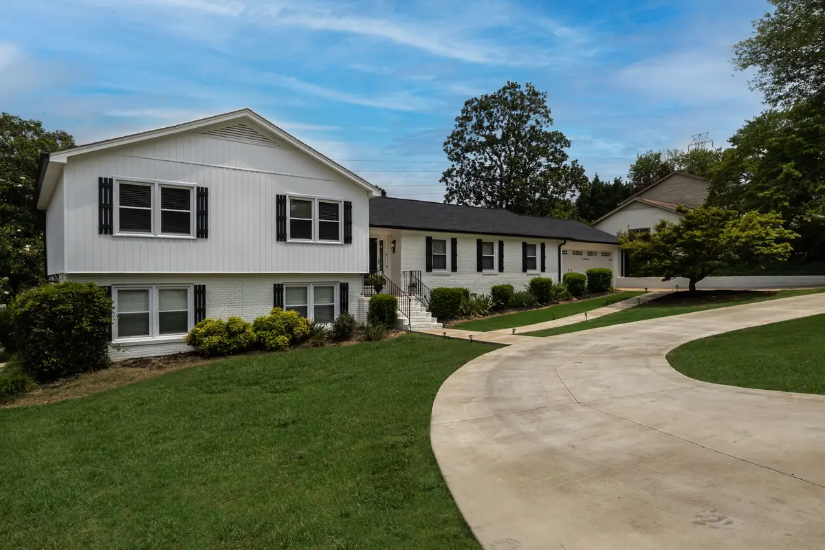 A poured concrete driveway curving from the street to a two-car garage