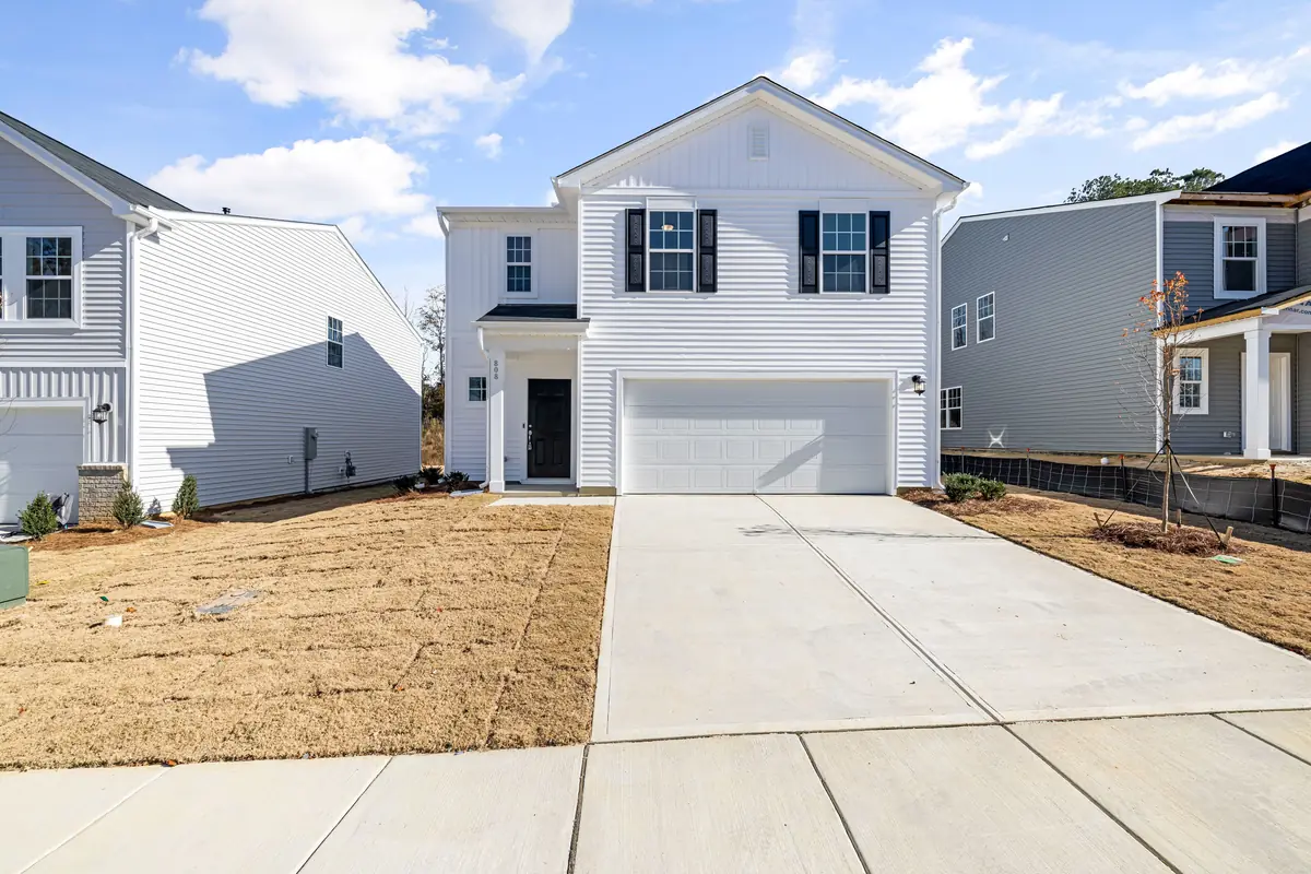 A newly poured concrete driveway running the full width of a two-car garage