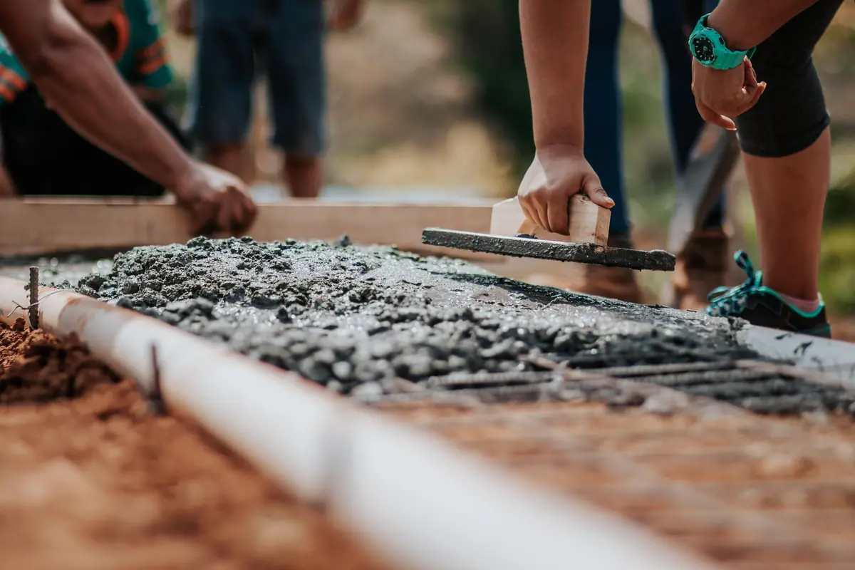 Hand-finishing the surface of a freshly poured concrete repair section
